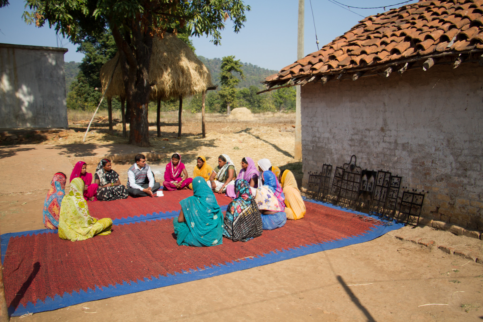 Mothers in a village, sitting in a circle at a meeting