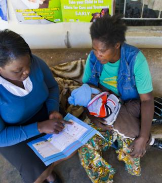 Healthcare worker reading to patient's mother