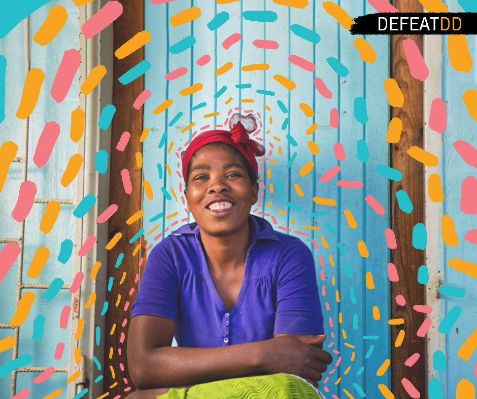 A woman smiling, sitting in front of a blue wooden door, wearing a purple shirt and red headscarf. Bright, colorful decorative lines surround her. The word "DEFEATDD" is in the top right corner.