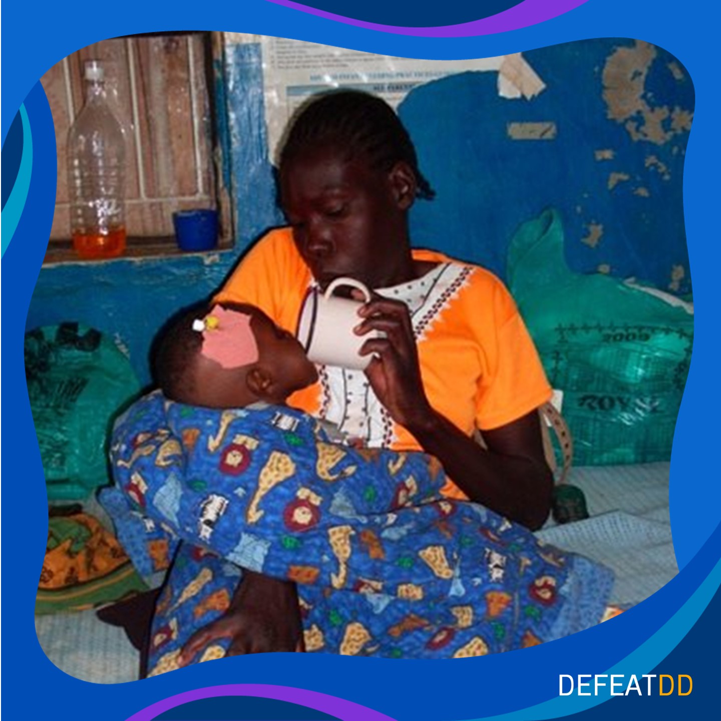 Mother tipping a cup or ORS into her daughter's mouth