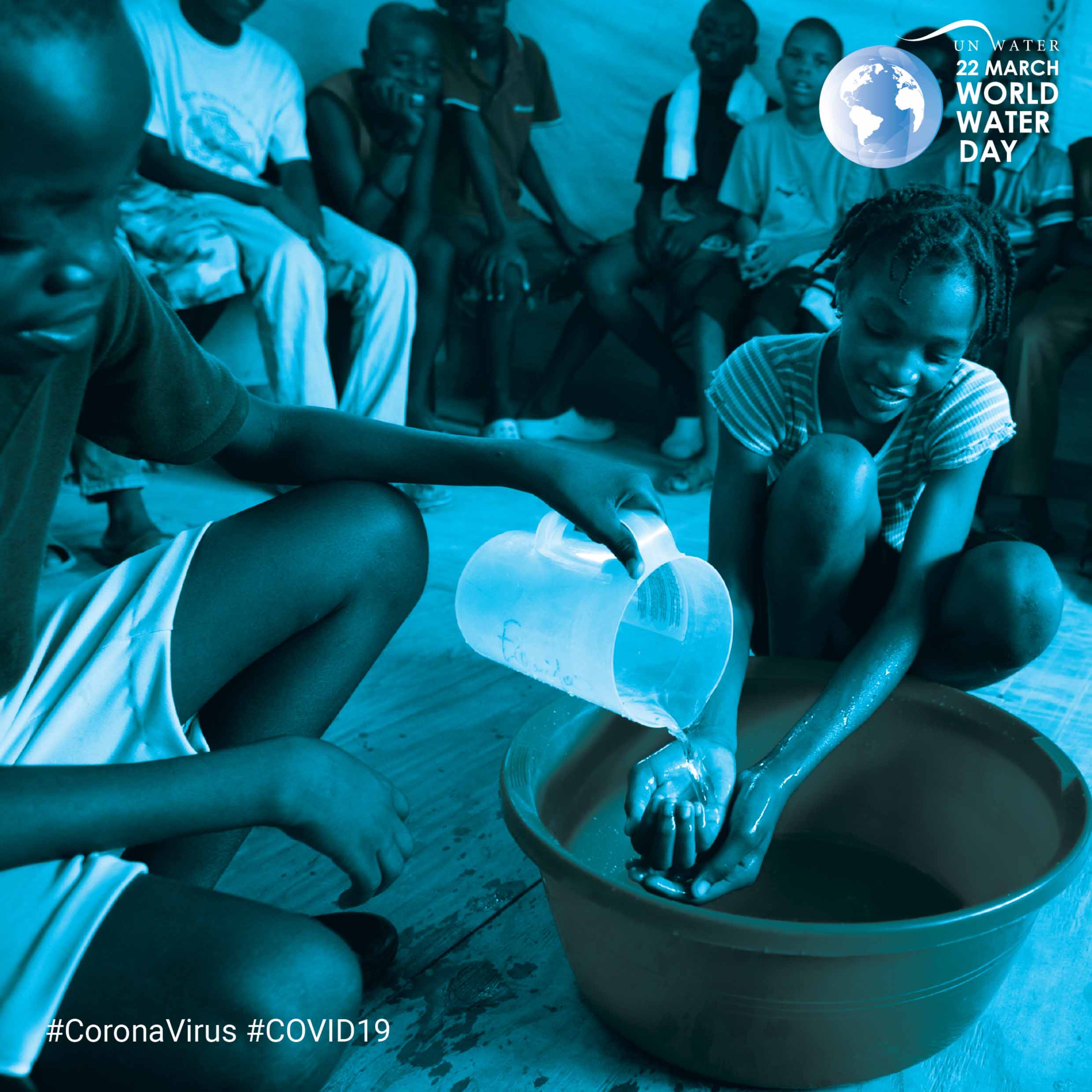 A young girl pours water from a jug to wash another child's hands over a basin. A group of people is seated in the background. The image is tinted blue, with text at the top displaying a globe and "22 March WORLD WATER DAY," and hashtags #CoronaVirus #COVID19.