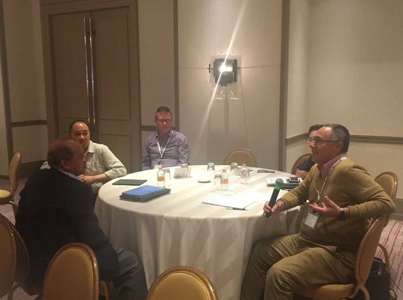 Workshop participants sitting and chatting around a table