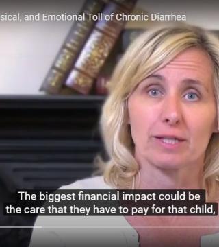 A woman with blonde hair speaks in an interview. Behind her are blurred books on a shelf. Caption at bottom reads, "The biggest financial impact could be the care that they have to pay for that child,". Title on the screen's top reads, "Physical, and Emotional Toll of Chronic Diarrhea".