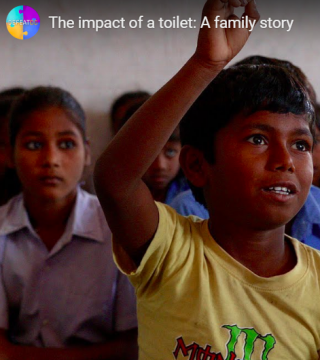 A young boy in a yellow shirt raises his hand in a classroom, looking enthusiastic. Other children sitting behind him pay attention. Text overlay at the top reads, "The impact of a toilet: A family story.